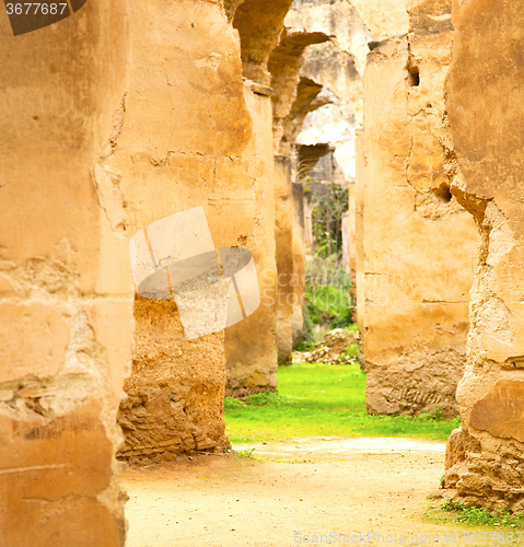 Image of old moroccan granary in the green grass and archway  wall