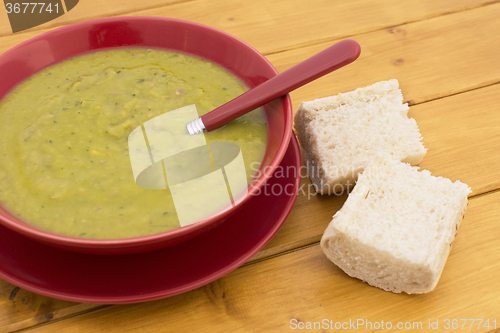 Image of Green pea and ham soup, served with bread
