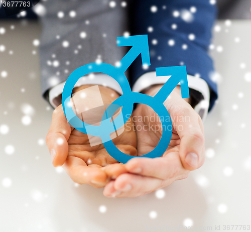 Image of close up of happy male gay couple with love symbol