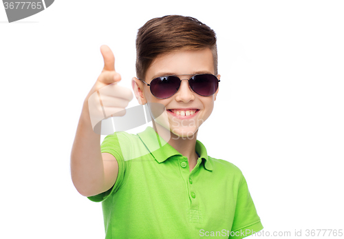 Image of smiling boy in sunglasses and green polo t-shirt