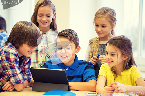 Image of group of school kids with tablet pc in classroom