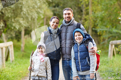 Image of happy family with backpacks hiking