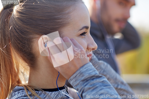 Image of happy woman with earphones listening to music