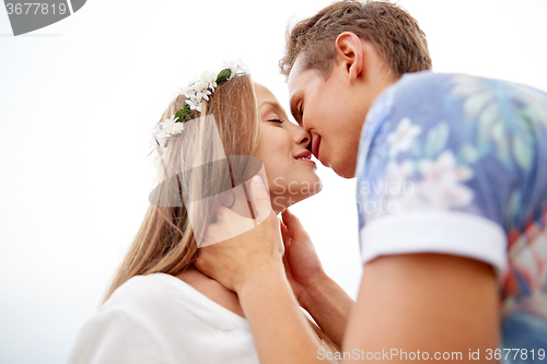 Image of happy smiling young hippie couple kissing outdoors