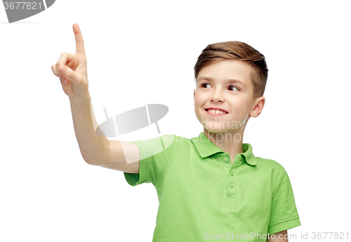 Image of happy boy in green polo t-shirt pointing finger up