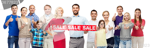 Image of happy people with red sale sign showing thumbs up