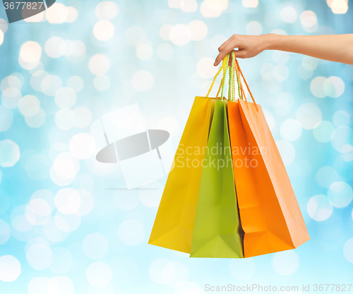 Image of close up of hand holding shopping bags