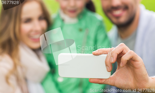 Image of close up of family taking selfie by smartphone