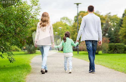 Image of happy family walking in summer park