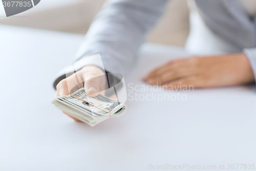 Image of close up of woman hands holding us dollar money