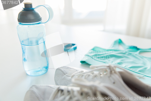 Image of close up of sportswear, bracelet and bottle