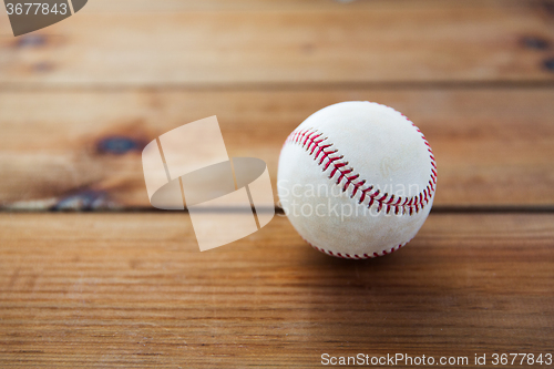 Image of close up of baseball ball on wooden floor