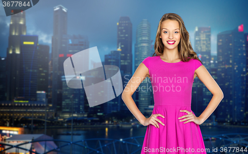 Image of happy young woman or teen girl over night city