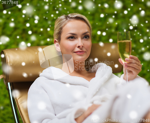 Image of beautiful young woman drinking champagne at spa