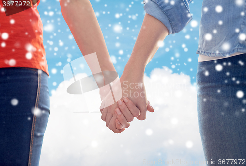 Image of close up of lesbian couple holding hands