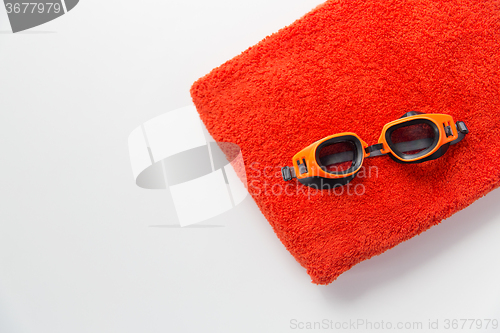 Image of close up of swimming goggles and towel