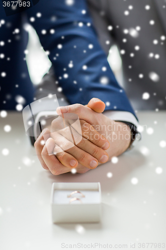 Image of close up of male gay couple and wedding rings