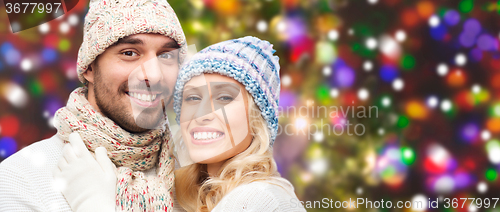 Image of smiling couple in winter clothes hugging