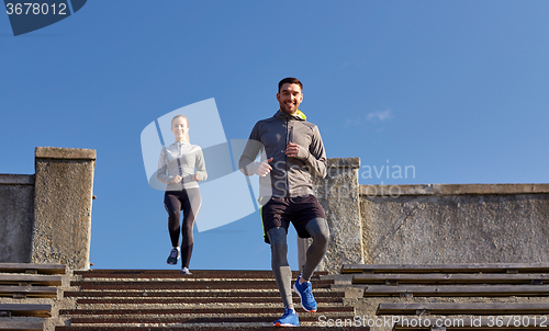 Image of happy couple walking downstairs on stadium