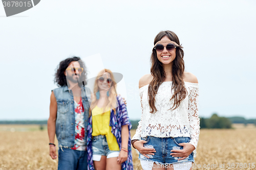 Image of smiling young hippie friends on cereal field