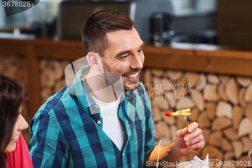 Image of happy man having dinner at restaurant