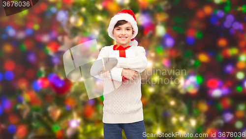 Image of smiling happy boy in santa hat with gift box