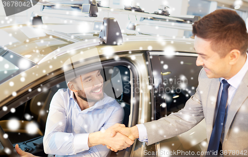 Image of happy man with car dealer in auto show or salon