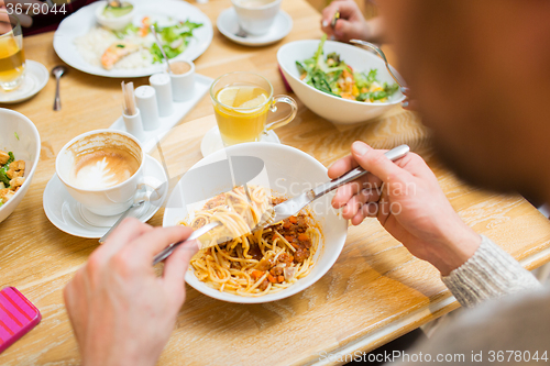 Image of close up man eating pasta for dinner at restaurant