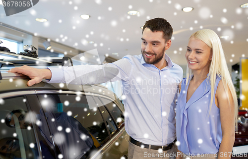 Image of happy couple buying car in auto show or salon