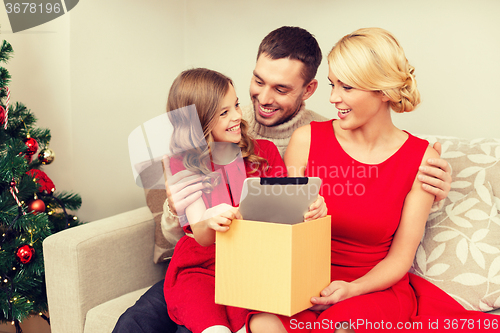 Image of smiling family with tablet pc