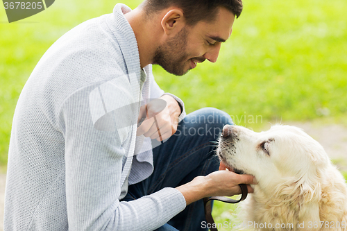 Image of close up of man with labrador dog outdoors