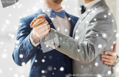 Image of close up of happy male gay couple dancing