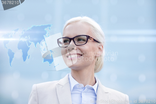 Image of young smiling businesswoman in eyeglasses outdoors