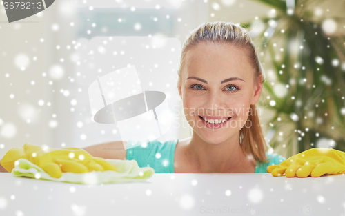 Image of happy woman cleaning table at home kitchen