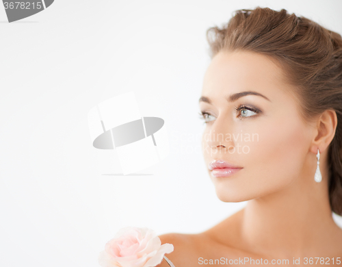 Image of young woman with rose flower