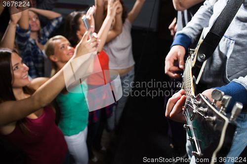 Image of close up of people at music concert in night club