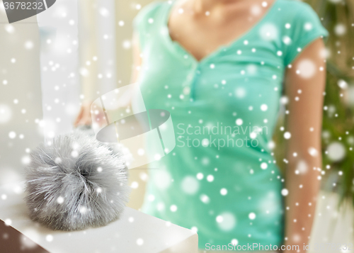 Image of close up of woman with duster cleaning at home