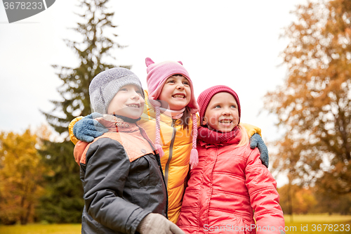Image of group of happy children hugging in autumn park