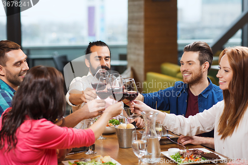 Image of friends dining and drinking wine at restaurant
