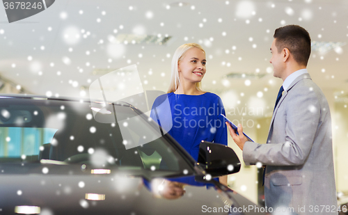 Image of happy woman with car dealer in auto show or salon