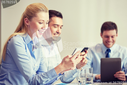 Image of businesspeople with smartphones and tablet pc