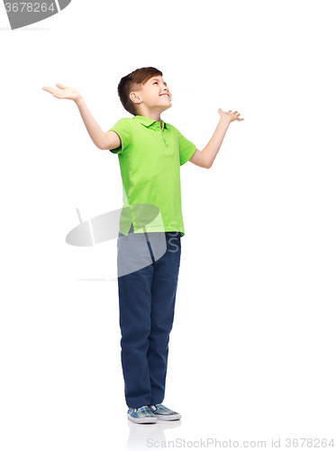 Image of happy boy in polo t-shirt raising hands up