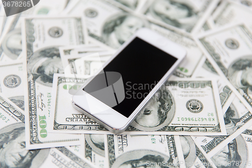 Image of close up of smartphone and dollar money