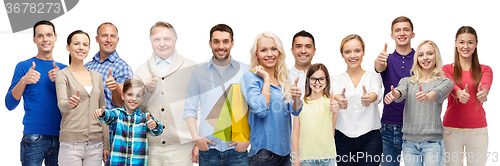 Image of happy people with shopping bags showing thumbs up