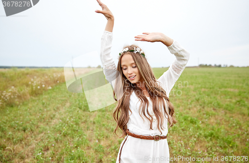 Image of smiling young hippie woman on cereal field