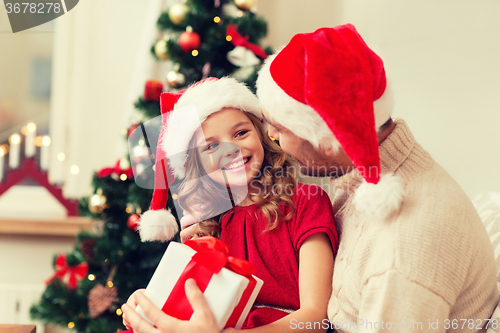 Image of smiling father and daughter holding gift box