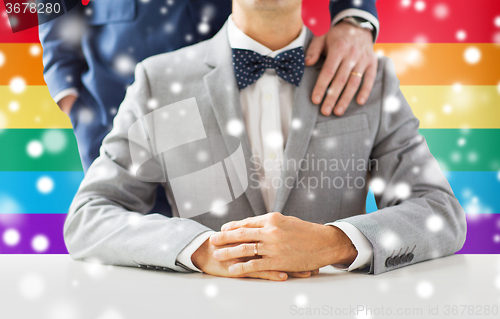 Image of close up of male gay couple with wedding rings on