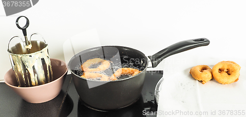 Image of Donut maker in bowl, donuts boiling and donuts resting