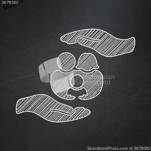 Image of Insurance concept: Family And Palm on chalkboard background