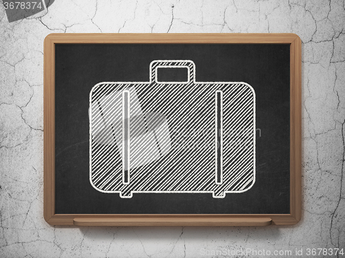 Image of Tourism concept: Bag on chalkboard background